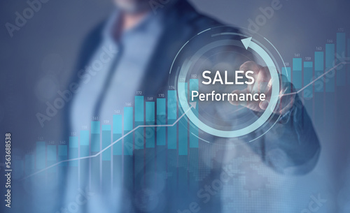 Businessman using laptop and tablet analyze economic charts and sales data on virtual interface
