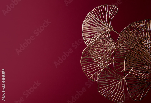 Golden Ginkgo Biloba Leaves Against Dark Red Background. Luxury Happy Valentine Day Poster Print or Banner Background.