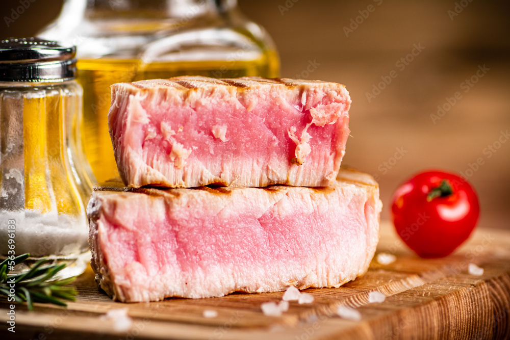A piece of grilled tuna on a cutting board. 