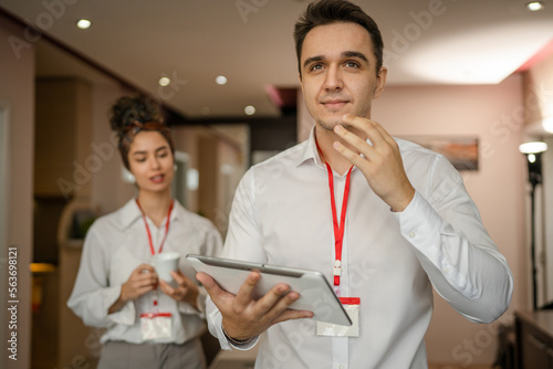 Young couple man and woman standing in hotel room talk about business
