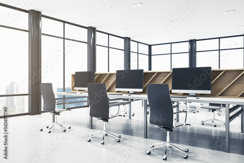 Contemporary spacious bright coworking office interior. Wooden and concrete materials. Panoramic window with city view and daylight. Corporation, law and legal concept. 3D Rendering.