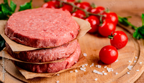 Raw burger with tomatoes. 
