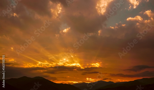 colorful sunset on top of Caucasian mountains. Sunset in mountain over peak. Sun light and early morning or evening mountain sky background. Dilijan, Armenia,