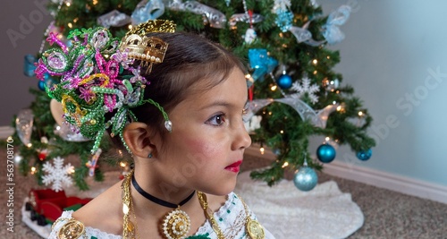 Girl in front of a Christmas tree.  photo