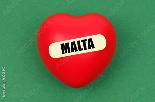 On a green surface lies a red heart with the inscription - Malta