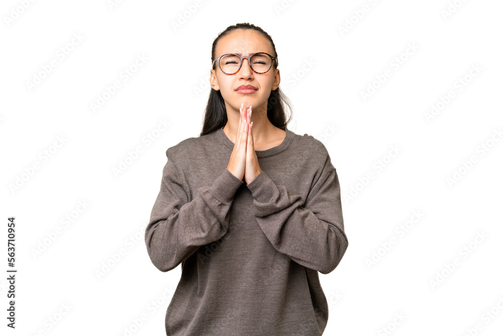 Young Arabian woman over isolated chroma key background keeps palm together. Person asks for something Young Arabian woman over isolated chroma key background keeps palm together. Person asks for something