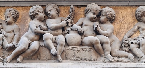 Lots of stone children sitting next to each other and playing games