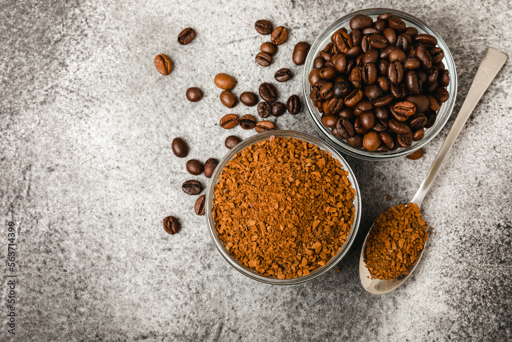 Instant coffee and coffee beans on a black stone background. Aromatic coffee drink. Place for text. Space for copy text Instant coffee and coffee beans on a black stone background. Aromatic coffee drink. Place for text. Space for copy text