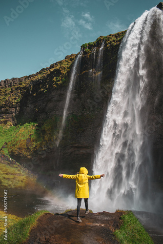 Amazing Waterfall in Iceland, Sunny Day, Golden Circle Woman in Yellow Coat 