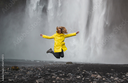 Amazing Waterfall in Iceland, Sunny Day, Golden Circle Woman in Yellow Coat 