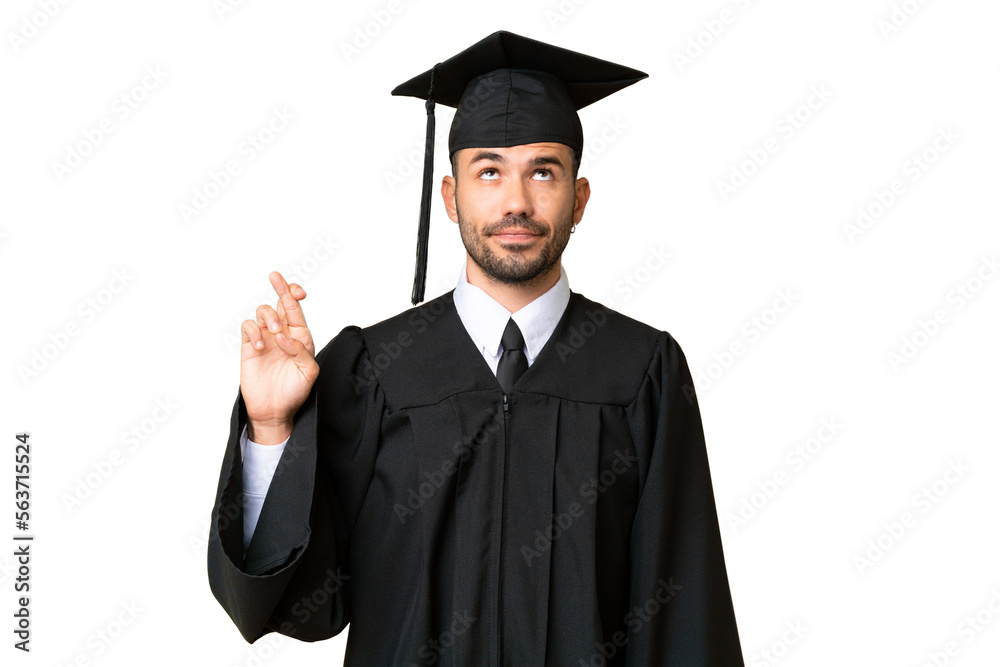 Young university graduate man over isolated chroma key background with fingers crossing and wishing the best Young university graduate man over isolated chroma key background with fingers crossing and wishing the best