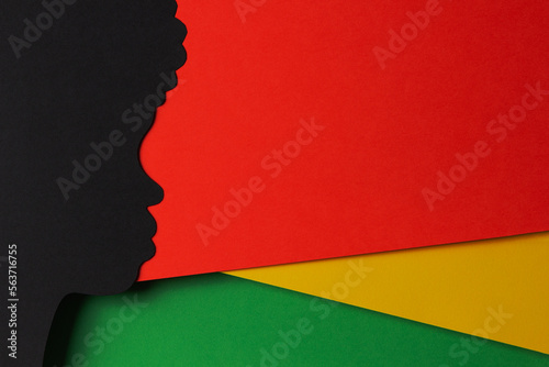 Black History Month color background. African Americans history celebration. Abstract geometric red, yellow, green color background with black paper cut people silhouette. Top view