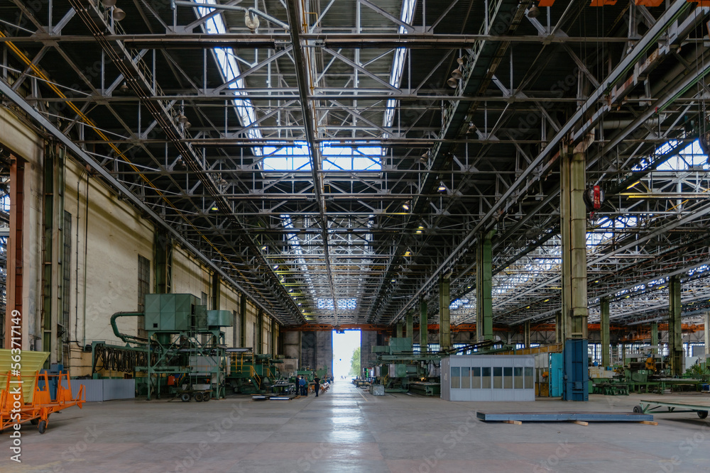 Heavy mechanical engineering factory production line. Interior of large worksop Heavy mechanical engineering factory production line. Interior of large worksop
