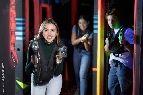 Young woman playing lasertag in arena