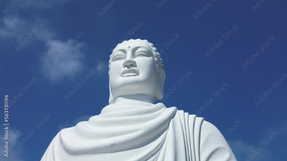 Aerial view boundless clear blue sky and Big Buddha of Vietnam.Big Buddha white statue in boundless clear blue sky. White Big Buddha Vietnam is the one of landmarks on Nha Trang Vietnam. 4K