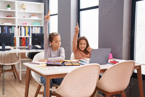 Two kids students using computer having online lesson at classroom