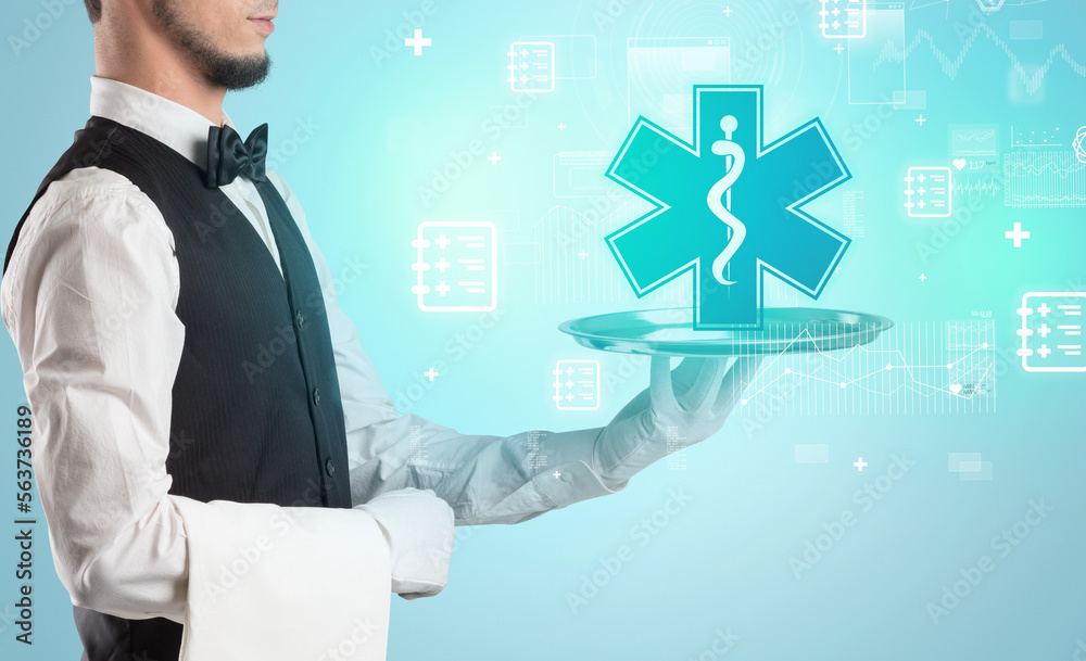 Handsome young waiter in tuxedo holding healthcare icons on tray Handsome young waiter in tuxedo holding healthcare icons on tray