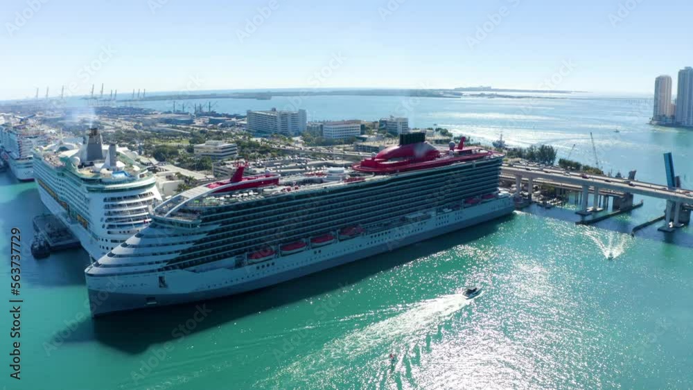 Aerial, 4K. Cruise Ship at port of Miami and skyscrapers behind it. Florida, USA. Cruise Ship Departing From Miami Port, Sunset Aerial Drone. Cruise ship from above with Drone. High quality 4k footage