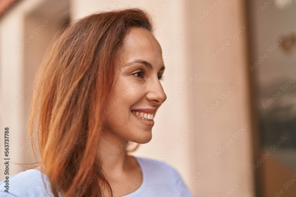 Young woman smiling confident looking to the side at street Young woman smiling confident looking to the side at street