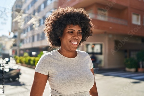 African american woman smiling confident looking to the side at street © Krakenimages.com