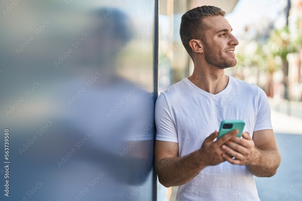Young caucasian man smiling confident using smartphone at street Young caucasian man smiling confident using smartphone at street