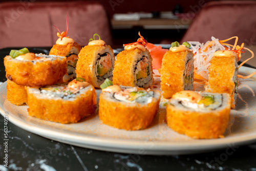 tempura sushi plate, stuffed with salmon, avocado and cream cheese. sushi in restaurant