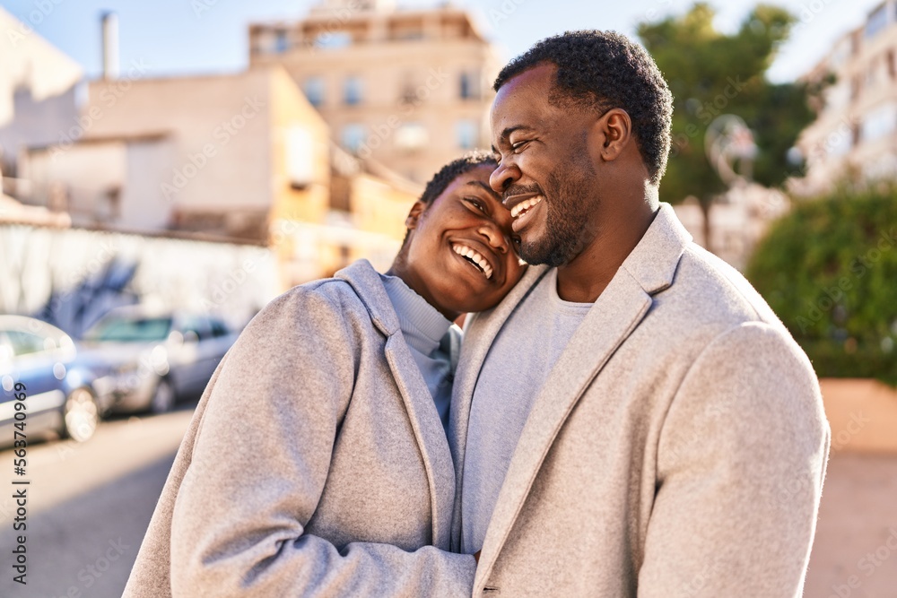 Man and woman couple hugging each other standing at street Man and woman couple hugging each other standing at street