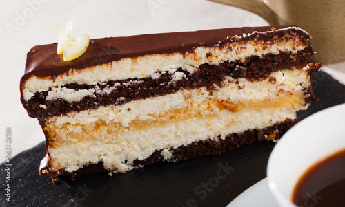 Tasty piece of lemon-chocolate cake served on slate