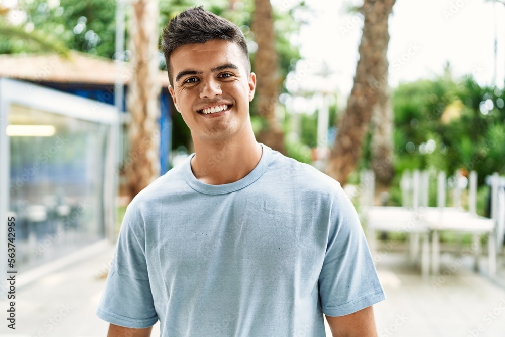 Young hispanic man smiling confident standing at street Young hispanic man smiling confident standing at street