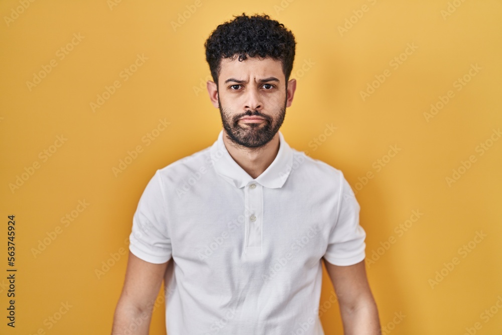 Arab man standing over yellow background depressed and worry for distress, crying angry and afraid. sad expression. Arab man standing over yellow background depressed and worry for distress, crying angry and afraid. sad expression.