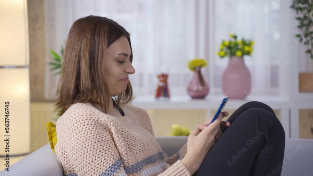Young woman holding smartphone having fun using mobile apps laughing confused at mobile phone screen. Young woman holding smartphone having fun using mobile apps laughing confused at mobile phone screen.