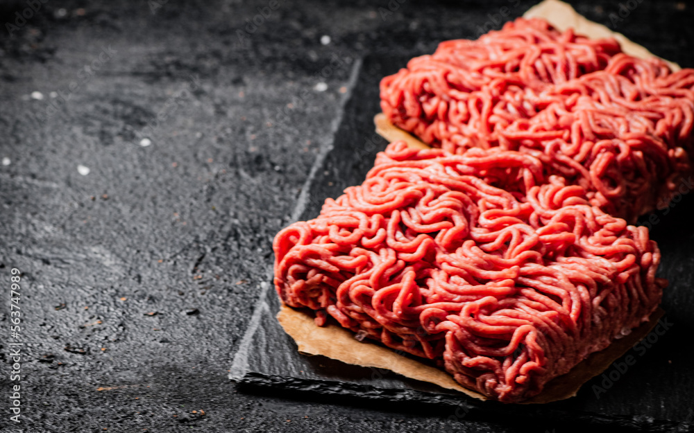 Raw minced meat on a stone board. Raw minced meat on a stone board.