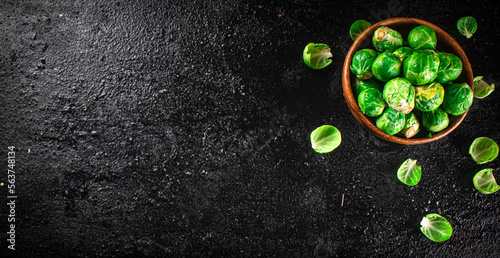 Brussels sprouts in a wooden bowl.  © Artem Shadrin