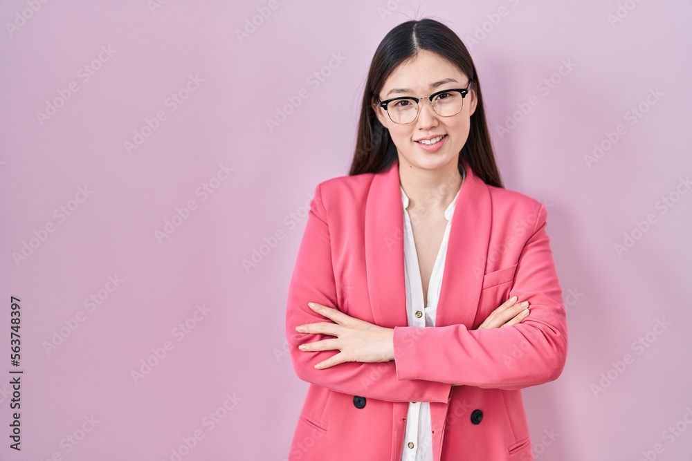 Chinese business young woman wearing glasses happy face smiling with crossed arms looking at the camera. positive person. Chinese business young woman wearing glasses happy face smiling with crossed arms looking at the camera. positive person.