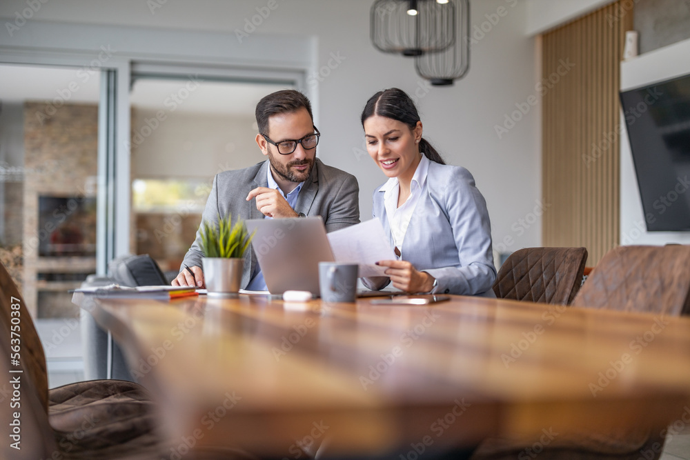 Two coworkers at the office discuss about business strategy of new investments Two coworkers at the office discuss about business strategy of new investments