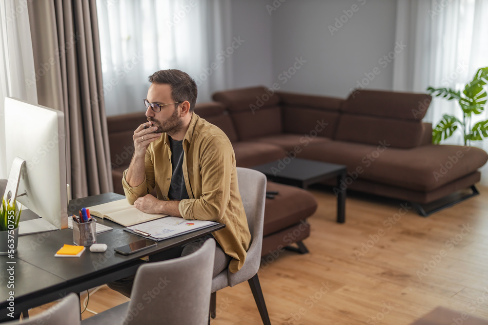 Male designer working at home office on new project
