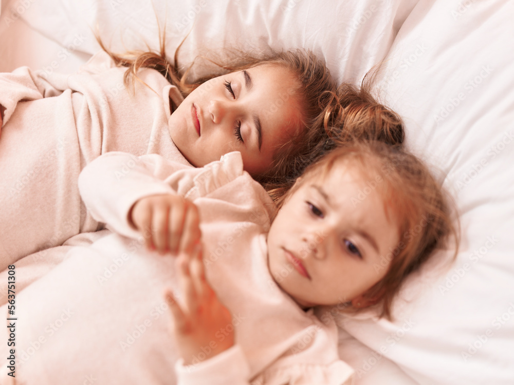 Two kids lying on bed at bedroom