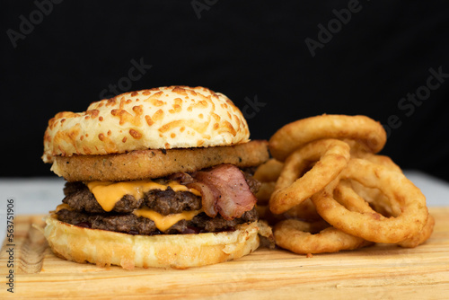 Burger cheese with potato in wooden table and black backgournd  photo