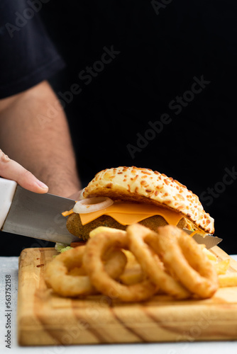 Burger cheese with potato in wooden table and black backgournd  photo