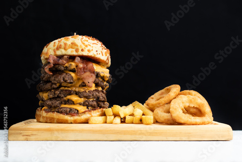 Burger cheese with potato in wooden table and black backgournd  photo