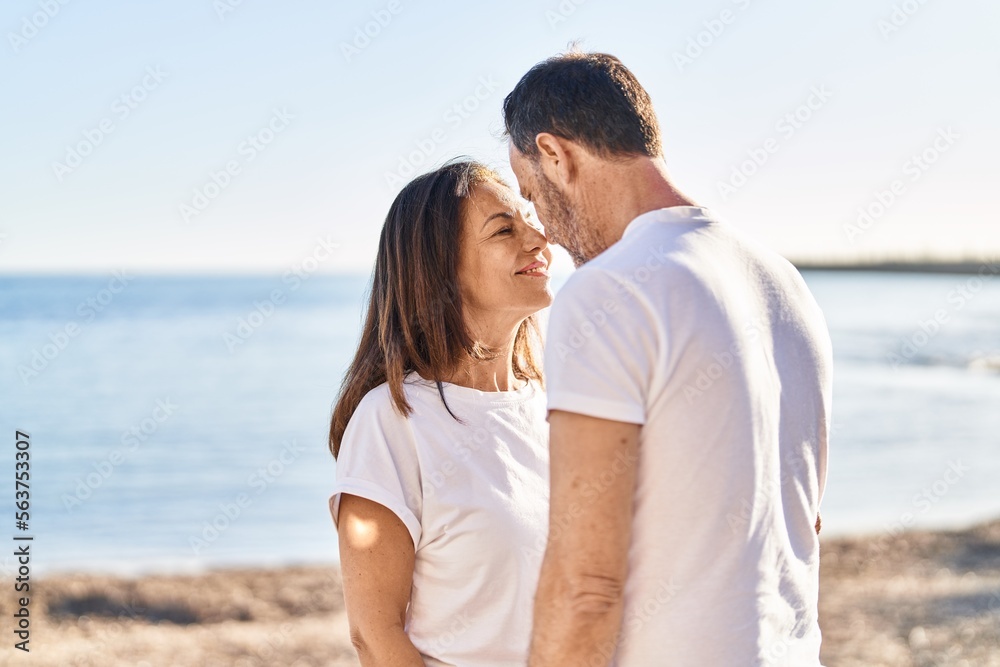 Middle age man and woman couple standing together at seaside Middle age man and woman couple standing together at seaside