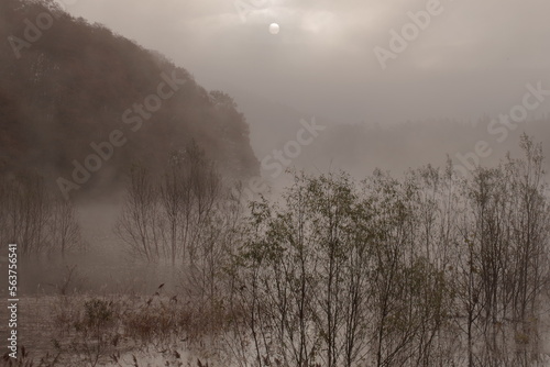 Landscape photo of a lake covered with morning fog. Winter morning photo. fantastic impression.