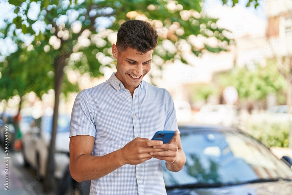 Young hispanic man smiling confident using smartphone at street Young hispanic man smiling confident using smartphone at street