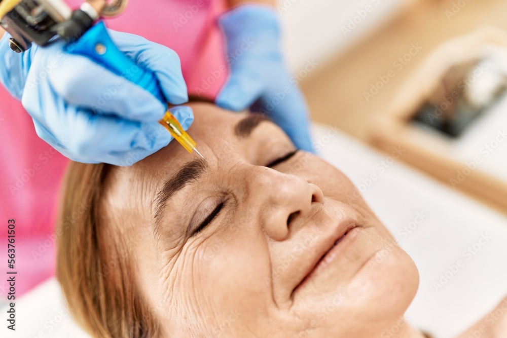 Middle age caucasian woman having anti-aging face treatment at beauty center Middle age caucasian woman having anti-aging face treatment at beauty center