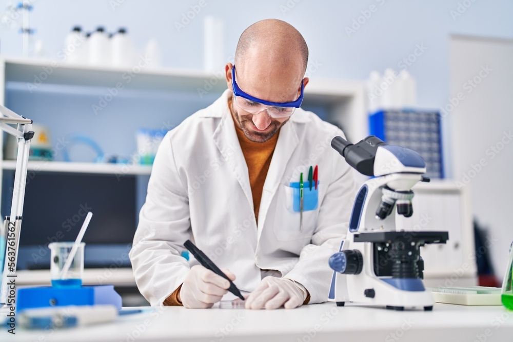 Young man scientist working at laboratory Young man scientist working at laboratory