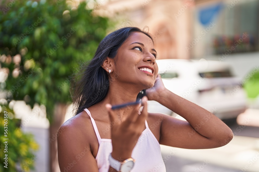 Young beautiful woman smiling confident talking on the smartphone at street Young beautiful woman smiling confident talking on the smartphone at street
