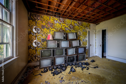 Pile of vintage television sets in an abandoned hotel room