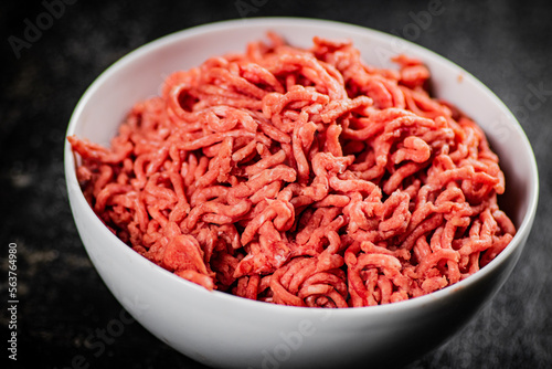 Bowl on the table with fresh minced meat. 