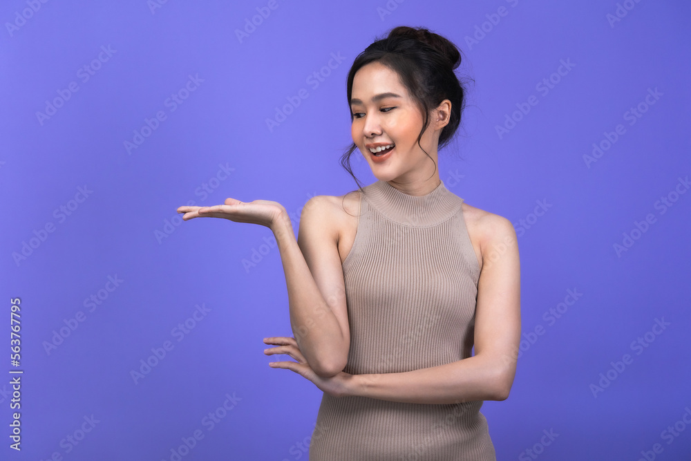 Beautiful young Asian woman pointing up to copy space and looking at camera with smile face and happy. Beautiful young Asian woman pointing up to copy space and looking at camera with smile face and happy.