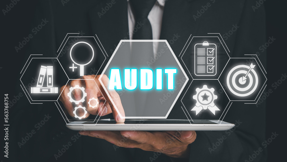 Fototapeta premium Audit Internal Financial Examination Accounting Business Finance concept, Businessman hand touching tablet conputer with audit icon on virtual screen,income statement, cash flow statement.